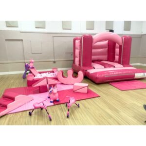Shades of pink bouncy castle and soft play package hire